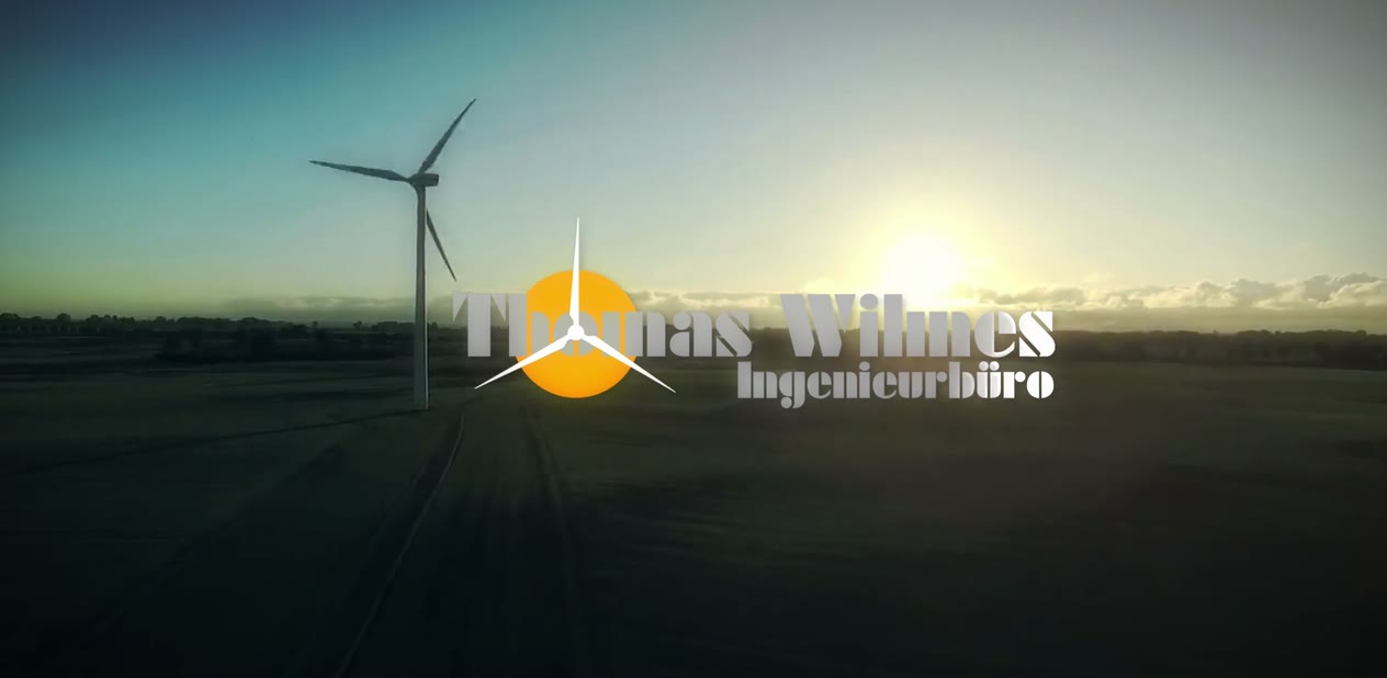 Still from the film: wind turbine against the light with the Thomas Wilmes Ingenieurbüro logo